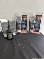 Lot showing two bottles of men's beard growth oil with dolppers and two tubes of hand and skin shield cream in original packaging