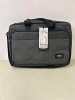 Front full view of Solo New York gray and black laptop bag with tag attached.