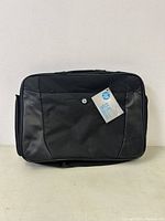 Front view of new black HP laptop bag with HP logo and 15.6 inch size tag.