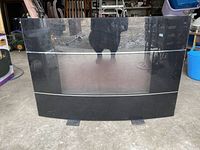 Front view of a black electric fireplace with glossy removable glass front