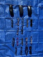 Top view of sunglasses and prescription glasses on blue tarp including cases