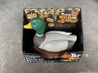 Front view of unopened Duck Dynasty talking duck toy in original box showing the duck figure and key feature text.