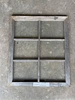 Front view of a wooden window frame with six glass panes arranged in two columns and three rows, rustic pine wood with weathered finish.