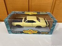 Full view of diecast 1969 Dodge Super Bee model in original ERTL American Muscle box, shows yellow car with black stripes, window plastic intact
