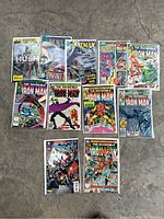 Full group of 11 bagged comics including Batman and Iron Man titles.