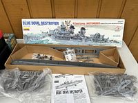 Photo of the open Blue Devil Destroyer model kit box showing hull parts, sprues in bags, and instruction sheet.