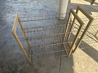 Two metal and wood shoe racks shown from above at an angle, placed on a concrete floor.