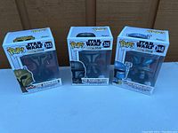 Three Star Wars Funko Pop figures boxed including The Armorer and two Mandalorians