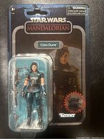 Front view of the Star Wars The Mandalorian Cara Dune carbonized figure mint on card with packaging and accessories visible.