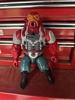 Front view of 1986 vintage red and gray alien creature action figure showing detailed face, torso, arms, and legs.