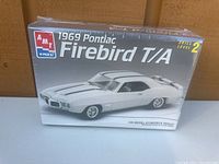 Front view of sealed AMT 1969 Pontiac Firebird T/A model kit box, showing skill level 2 and image of the car model in white.