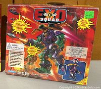 Front face of one Exo Squad toy box showing character and mech with price label