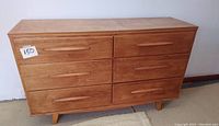 Front view of six drawer wooden dresser