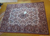 Full view of rectangular burgundy and beige area rug laid on yellow carpeted floor showing complete design and dimensions