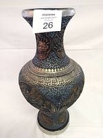 Full view of decorative floor vase showing body and neck relief detail with light and dark finishes.