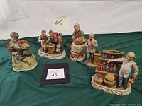 Four Old Town figurines displayed on green cloth background with label '45' and info card.