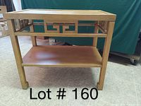 Full view of retro solid wood end table with geometric design and lower shelf on tiled floor.