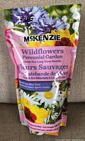 Front view of sealed McKenzie Wildflowers Perennial Garden seed bag showing colorful flower images and product details.