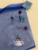 Full view of the multi-colored glass crystal suncatcher with large faceted prism and hanging loop