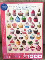 Front of puzzle box showing colorful image of cupcakes, 1000 pieces, Eurographics branding and sealed condition.