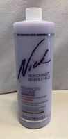 Front view of a 32oz lavender bottle of Nick Chavez Advanced Volume Shampoo with black and purple branding text.