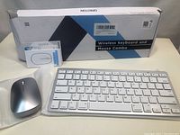 Wireless keyboard and mouse combo in original packaging with slightly damaged box