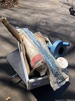 Box with packaged Calgon cartridge filters, blue plastic drain snake container, and metal handicap grab bar visible.