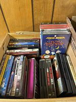 Box with multiple DVD movies and shows including Charlie Brown, Christmas, and others.