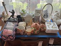 Full overview of tea set items and additional decorative pieces on table showing variety of items