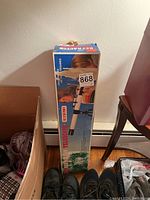 Photo of the telescope box standing upright with visible product graphics and branding.