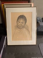 Full framed pencil drawing of Native child by C. Coughlin from 1989 on toned paper, showing entire artwork and frame.