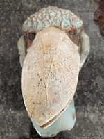Front view of the clay emu art showing textured turquoise glaze and natural clay colors with intricate beak details.