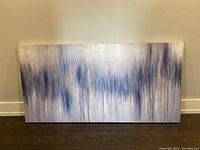 Front view of one abstract painting leaning against the wall on dark wood floor, featuring vertical brush strokes