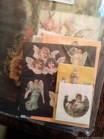 Close up of Victorian angel and floral diecuts with delicate color and detailed printing