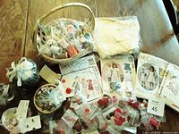 Sewing basket filled with spools of thread, needles, scissors, vintage children's sewing patterns, and fabric.