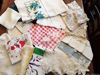 Group of assorted vintage linens including embroidered, crocheted and printed pieces