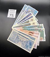 Full set of Southeast Asian paper currency notes fanned out, showing various denominations and styles.