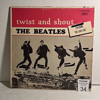 Front view of The Beatles 'Twist and Shout' LP album cover showing artwork and text details including Capitol Records logo.