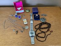 Overall shot of jewelry and watch laid out on table showing all items.