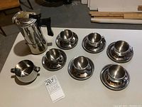 Set of 6 stainless steel espresso cups with saucers, vintage moka espresso machine, and sugar bowl.
