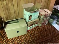 Boxes stacked containing mason jars and other items.