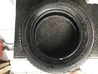 Photo of Yokohama winter tire showing 185/65 R15 size and brand name.