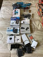 Photo showing all cell phone accessories laid out including boxes and loose cables.