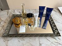 Full view of vintage mirrored tray with all perfume bottles, Shania Twain Starlight body care tubes, amber trinket dish arranged neatly on the tray.