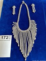 Full set displayed on blue background with lot number card visible