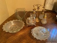 Full set of vintage glass bowls, oil and vinegar caddy with matching salt and pepper shakers on table