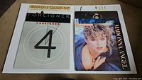 Photo showing front covers of Shaun Cassidy, Foreigner (4), and Madonna Angel vinyl records on beige carpet.
