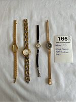 Photo showing all four watches laid out on white background with note card listing brands: Bulova, Deauville Diamond, Citizen, Esprit.