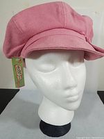 Front angled view of pink vintage hat on white mannequin head showing texture, shape, and original tag.