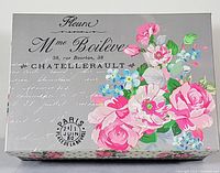 Photo of decorative box with floral print and vintage script showing exterior design of the memory box.